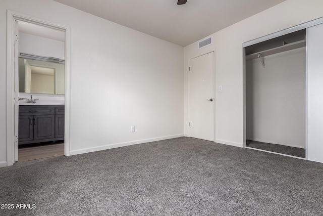 unfurnished bedroom with a closet, visible vents, carpet flooring, and a sink