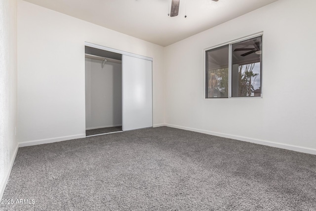 unfurnished bedroom with a closet, baseboards, carpet, and ceiling fan