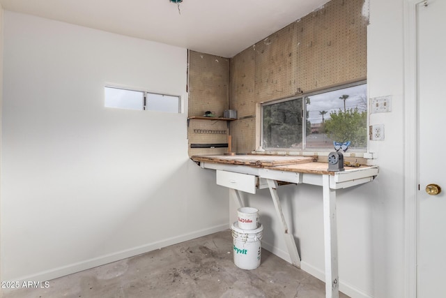 bathroom featuring baseboards and concrete floors