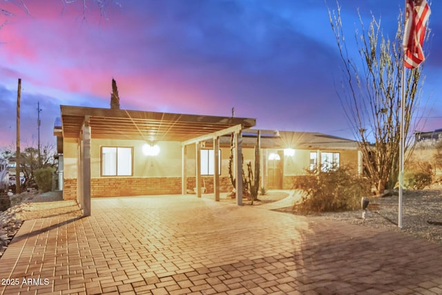 exterior space with brick floor and brick wall