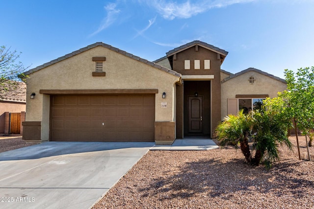 23789 W Chipman Rd, Buckeye, AZ 85326 - view of front of house featuring a tiled roof, a garage, stucco siding, fence, and concrete driveway