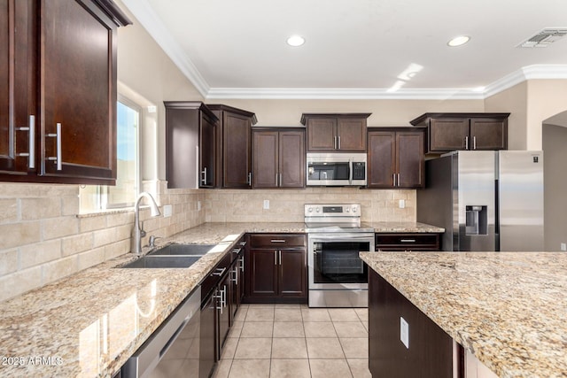 23789 W Chipman Rd, Buckeye, AZ 85326 - kitchen with visible vents, appliances with stainless steel finishes, light tile patterned flooring, a sink, and decorative backsplash