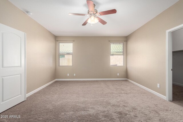 23789 W Chipman Rd, Buckeye, AZ 85326 - carpeted empty room featuring plenty of natural light, baseboards, and ceiling fan