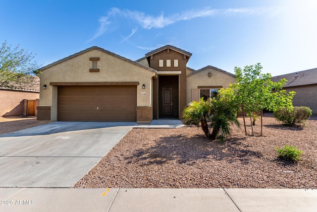 23789 W Chipman Rd, Buckeye, AZ 85326 - view of front of house featuring a garage, driveway, a tiled roof, and stucco siding