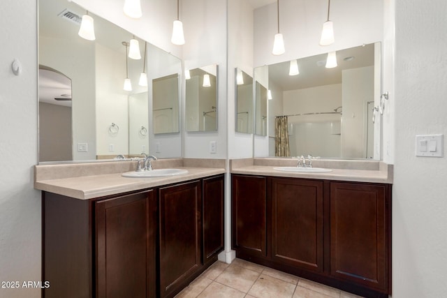 23789 W Chipman Rd, Buckeye, AZ 85326 - full bathroom with tile patterned floors, two vanities, and a sink