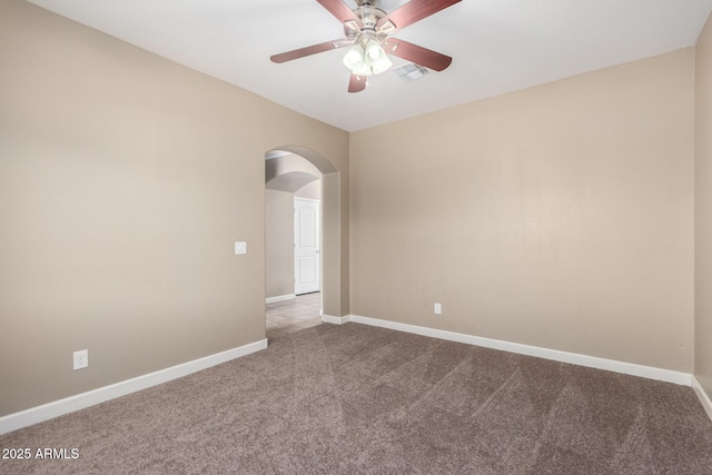 23789 W Chipman Rd, Buckeye, AZ 85326 - carpeted spare room with arched walkways, baseboards, a ceiling fan, and visible vents
