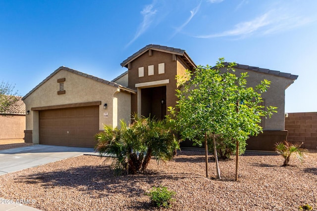 23789 W Chipman Rd, Buckeye, AZ 85326 - view of front of property featuring a tile roof, a garage, driveway, and stucco siding