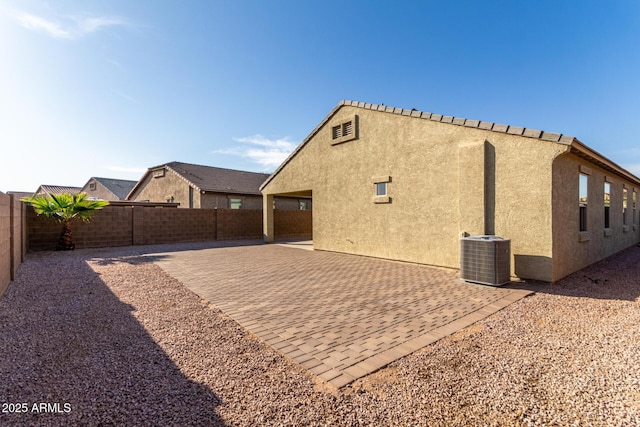 23789 W Chipman Rd, Buckeye, AZ 85326 - back of property with central air condition unit, a patio, a fenced backyard, and stucco siding