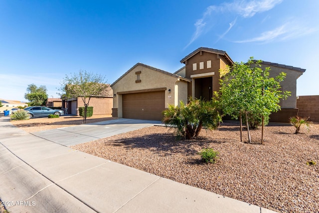 23789 W Chipman Rd, Buckeye, AZ 85326 - view of front of house featuring concrete driveway, stucco siding, a tile roof, and a garage