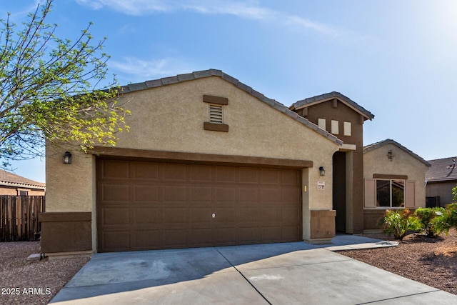 23789 W Chipman Rd, Buckeye, AZ 85326 - view of front facade featuring a garage, stucco siding, fence, a tile roof, and driveway