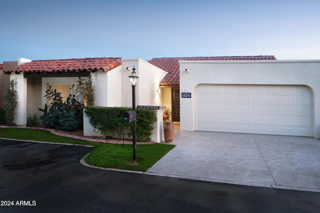 mediterranean / spanish home featuring a garage