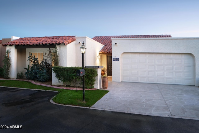 7331 E Valley Vista Dr, Scottsdale, AZ 85250 - mediterranean / spanish house with driveway, stucco siding, a tile roof, and a garage