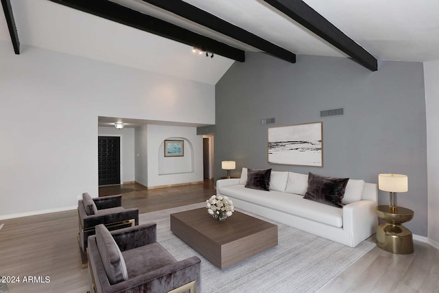 living room featuring beamed ceiling, wood-type flooring, and high vaulted ceiling