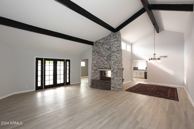 7331 E Valley Vista Dr, Scottsdale, AZ 85250 - unfurnished living room with beamed ceiling, high vaulted ceiling, light wood-style flooring, baseboards, and a stone fireplace