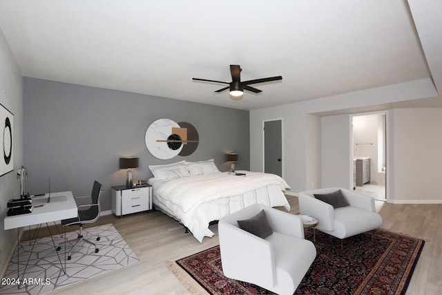 bedroom with connected bathroom, light hardwood / wood-style floors, and ceiling fan