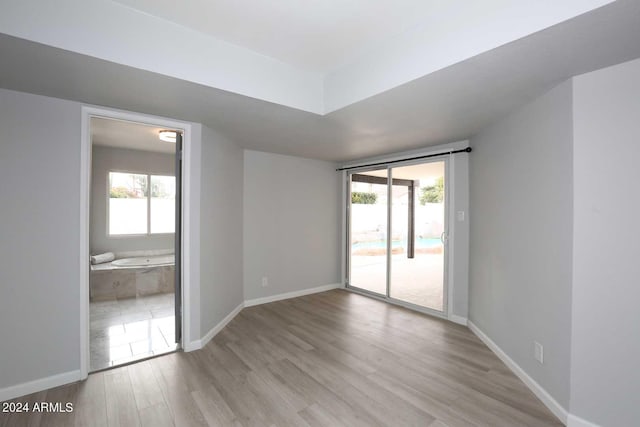 empty room with a healthy amount of sunlight and light wood-type flooring