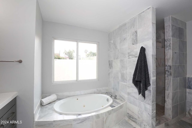 bathroom with vanity and independent shower and bath