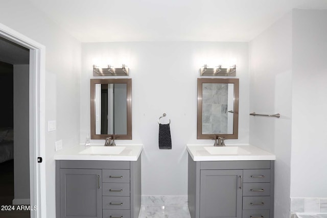 7331 E Valley Vista Dr, Scottsdale, AZ 85250 - full bath with marble look tile flooring, two vanities, and baseboards