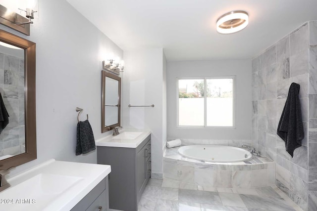 bathroom featuring vanity and tiled bath