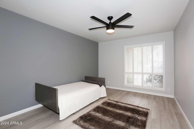 bedroom with ceiling fan and light hardwood / wood-style floors