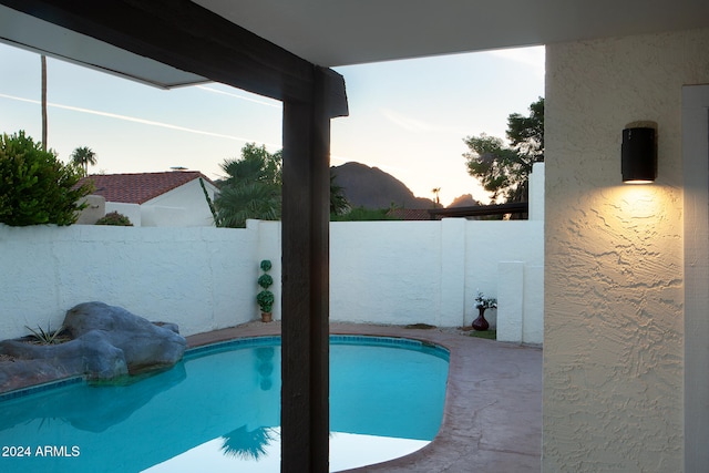 view of pool at dusk