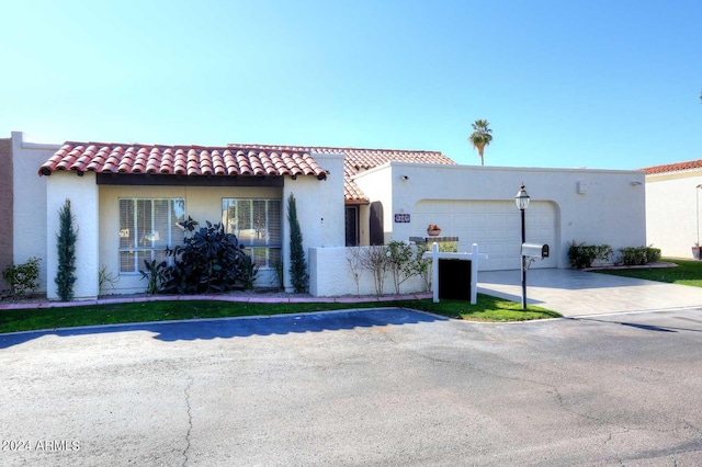 mediterranean / spanish-style home with a garage