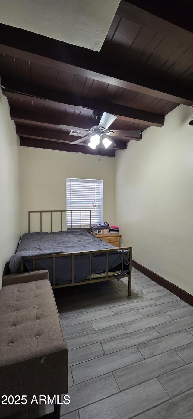 bedroom featuring wood ceiling, wood tiled floor, beam ceiling, and baseboards