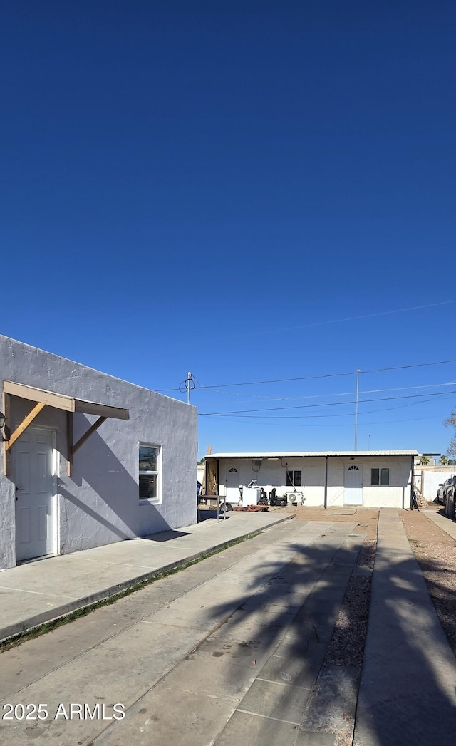 view of side of property featuring stucco siding