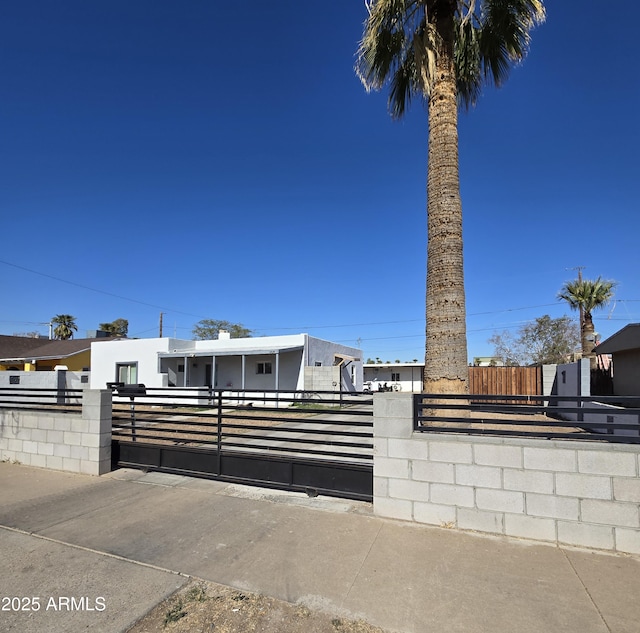 view of front of property with a fenced front yard and a gate