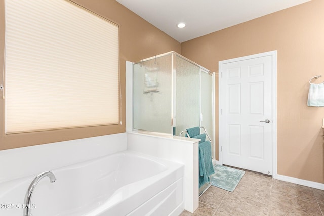 bathroom with tile patterned flooring, a shower stall, a bath, and baseboards