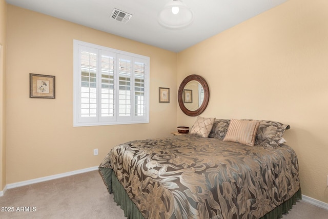 bedroom featuring baseboards, visible vents, and carpet flooring