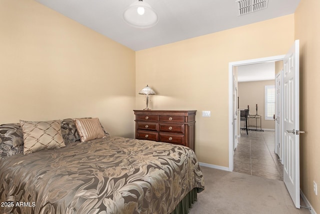 carpeted bedroom with baseboards and visible vents