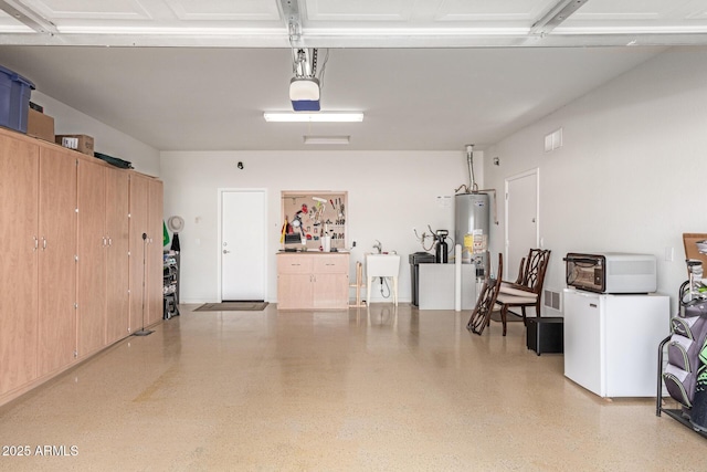 garage featuring water heater and a sink