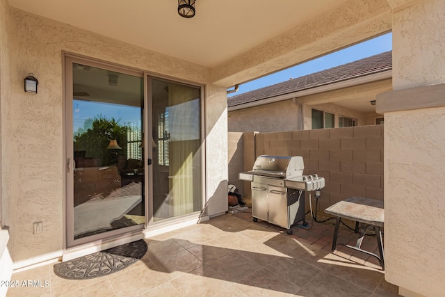 view of patio / terrace with area for grilling and fence