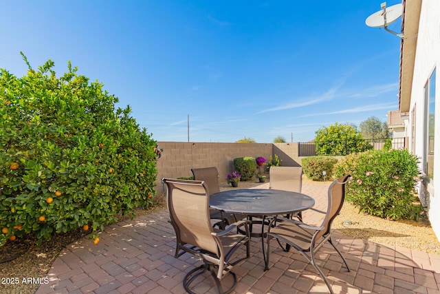 view of patio with a fenced backyard and outdoor dining area