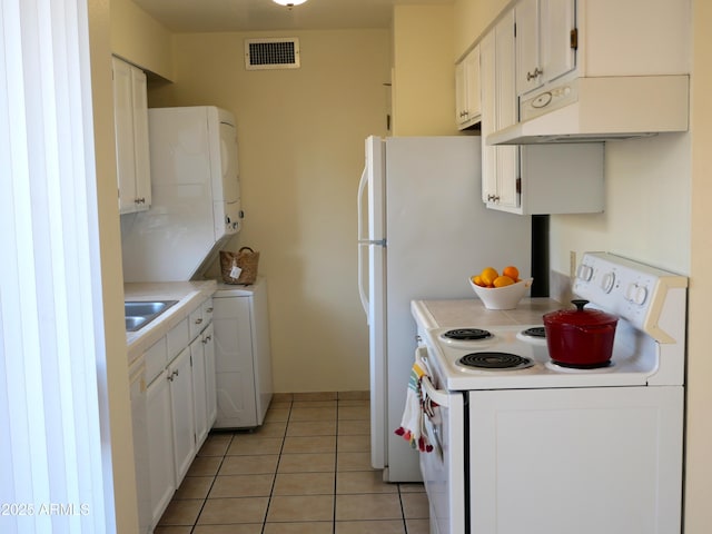 4359 Avenida Palermo Unit C, Sierra Vista, AZ 85635 - kitchen with white range with electric cooktop, under cabinet range hood, light tile patterned floors, and light countertops