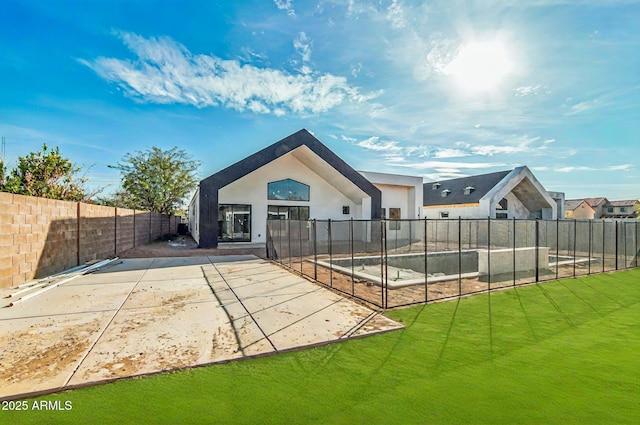 back of property featuring fence, stucco siding, a yard, and a patio