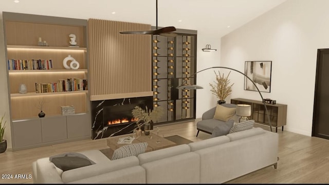 living area with baseboards, a lit fireplace, and light wood-type flooring