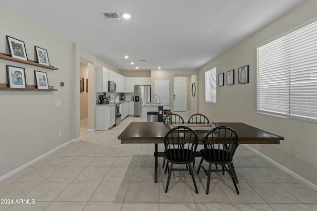 dining area with sink and light tile patterned floors