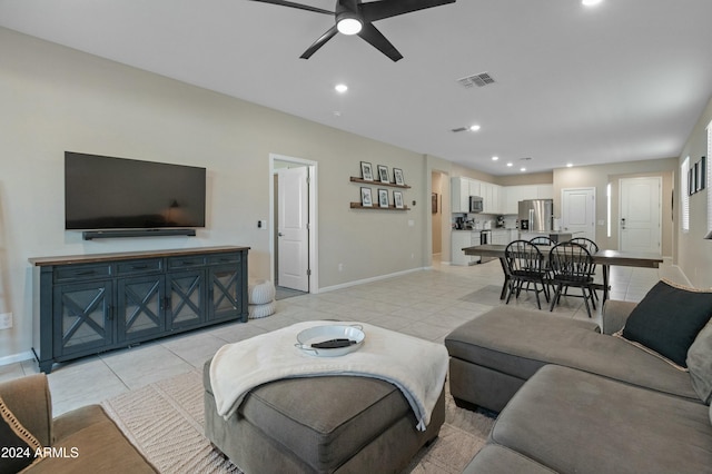 living room with ceiling fan and light tile patterned flooring