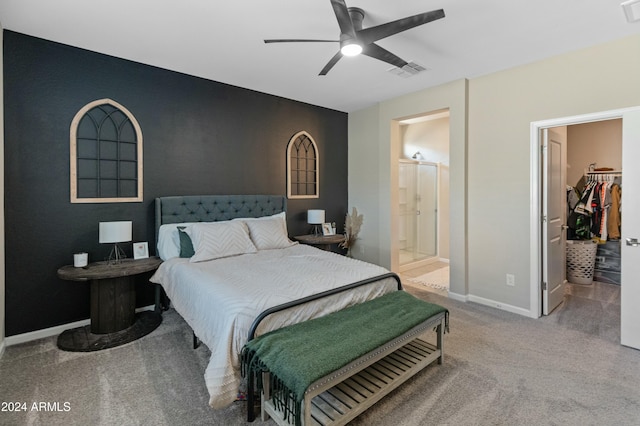 carpeted bedroom with a walk in closet, ceiling fan, a closet, and ensuite bathroom