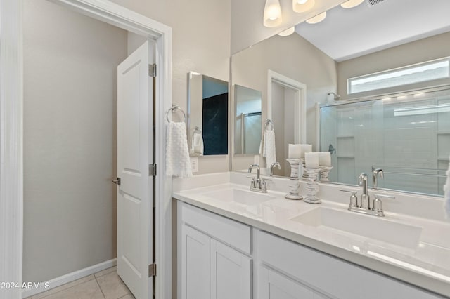 bathroom with tile patterned floors, vanity, and an enclosed shower