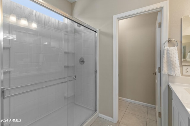 bathroom featuring tile patterned flooring, vanity, and an enclosed shower