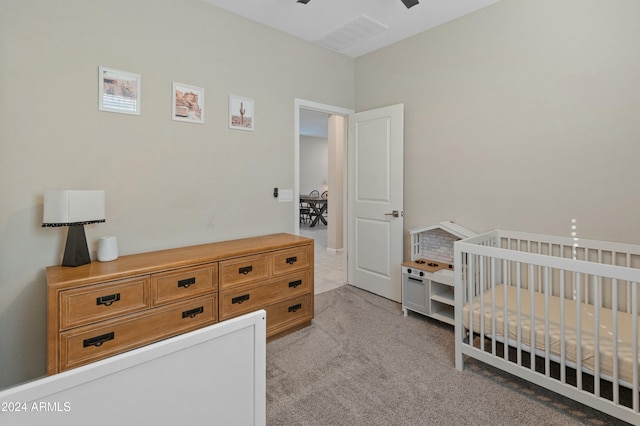 carpeted bedroom with a nursery area