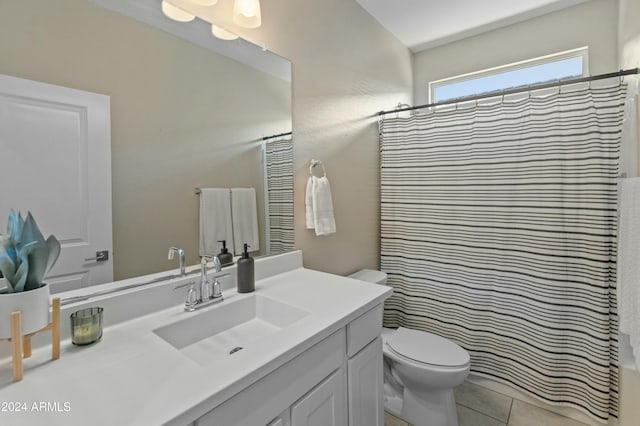 bathroom featuring toilet, a shower with curtain, vanity, and tile patterned floors