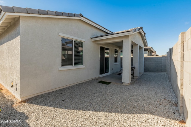 back of property featuring a patio