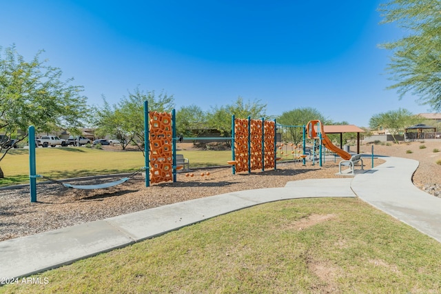 view of playground with a lawn