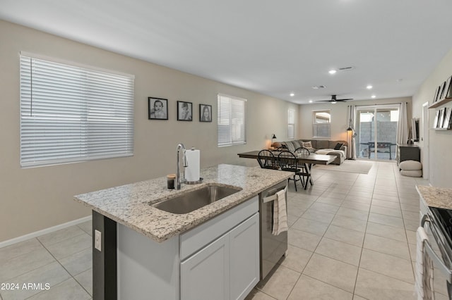 kitchen featuring ceiling fan, sink, stainless steel appliances, a kitchen island with sink, and white cabinets