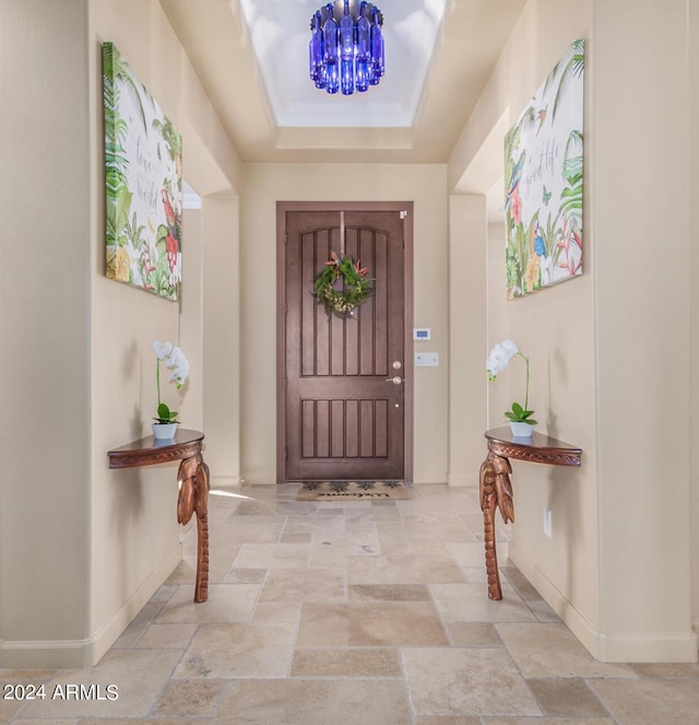 foyer with a tray ceiling