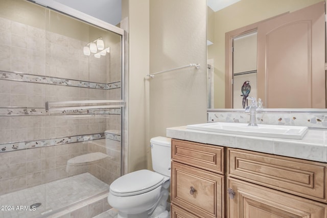 bathroom featuring vanity, toilet, and walk in shower